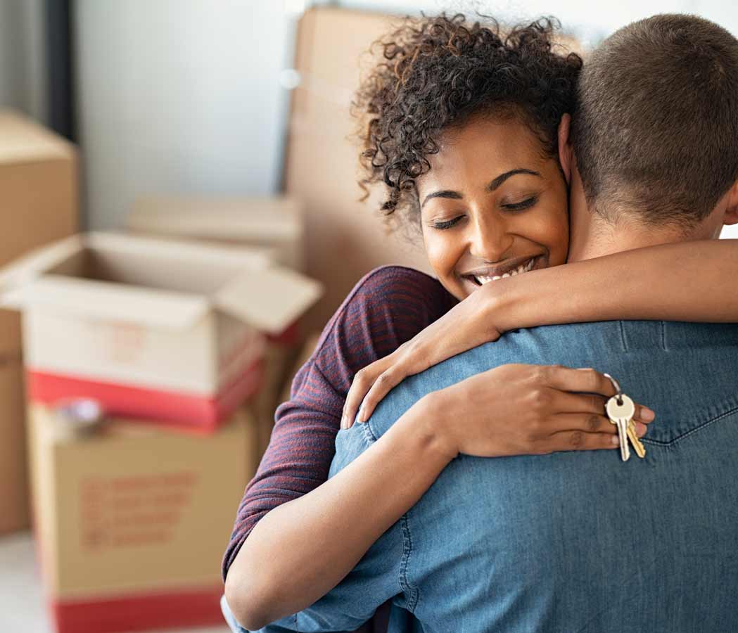 Couple hugging after moving into their new home